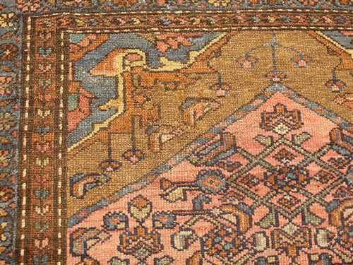 An antique Caucasian carpet with large worm areas after repair.