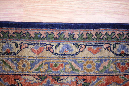 An oriental rug with damaged sides after repair.