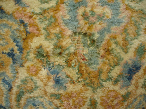 An example of an oriental rug with moth damage.